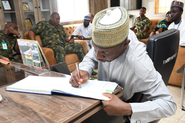 Dr. Suleiman A. Suleiman Performing the traditional Signing of the Visitors Register 